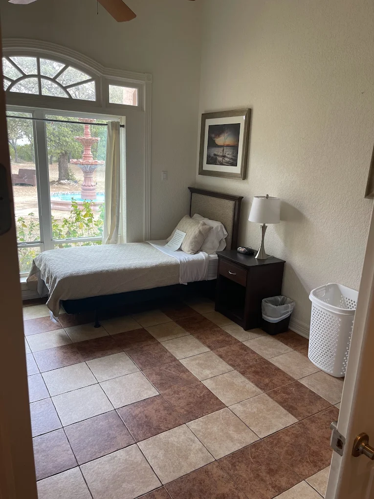 Bedroom with single bed and large window view