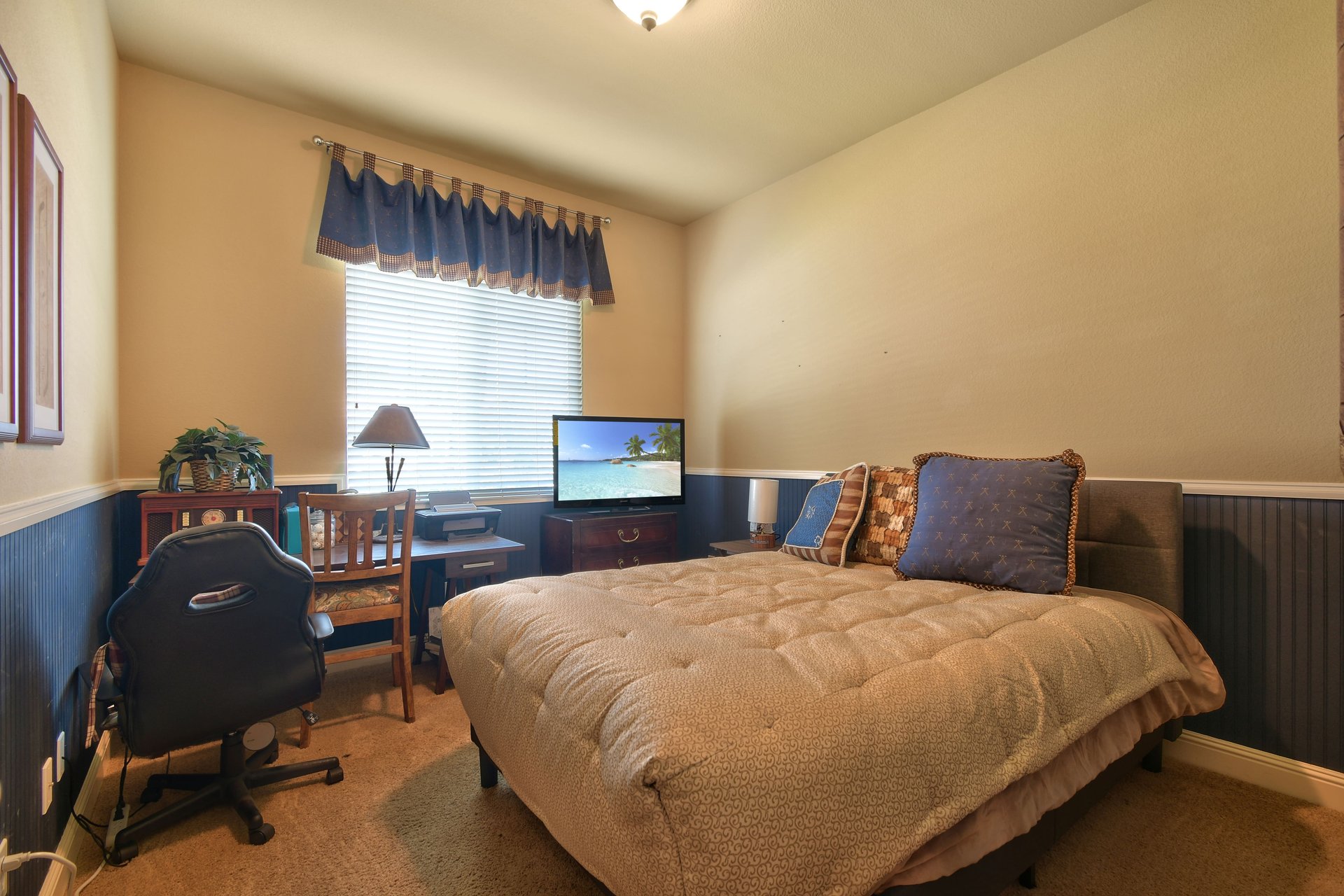 Cozy bedroom with desk, chair, and window lighting