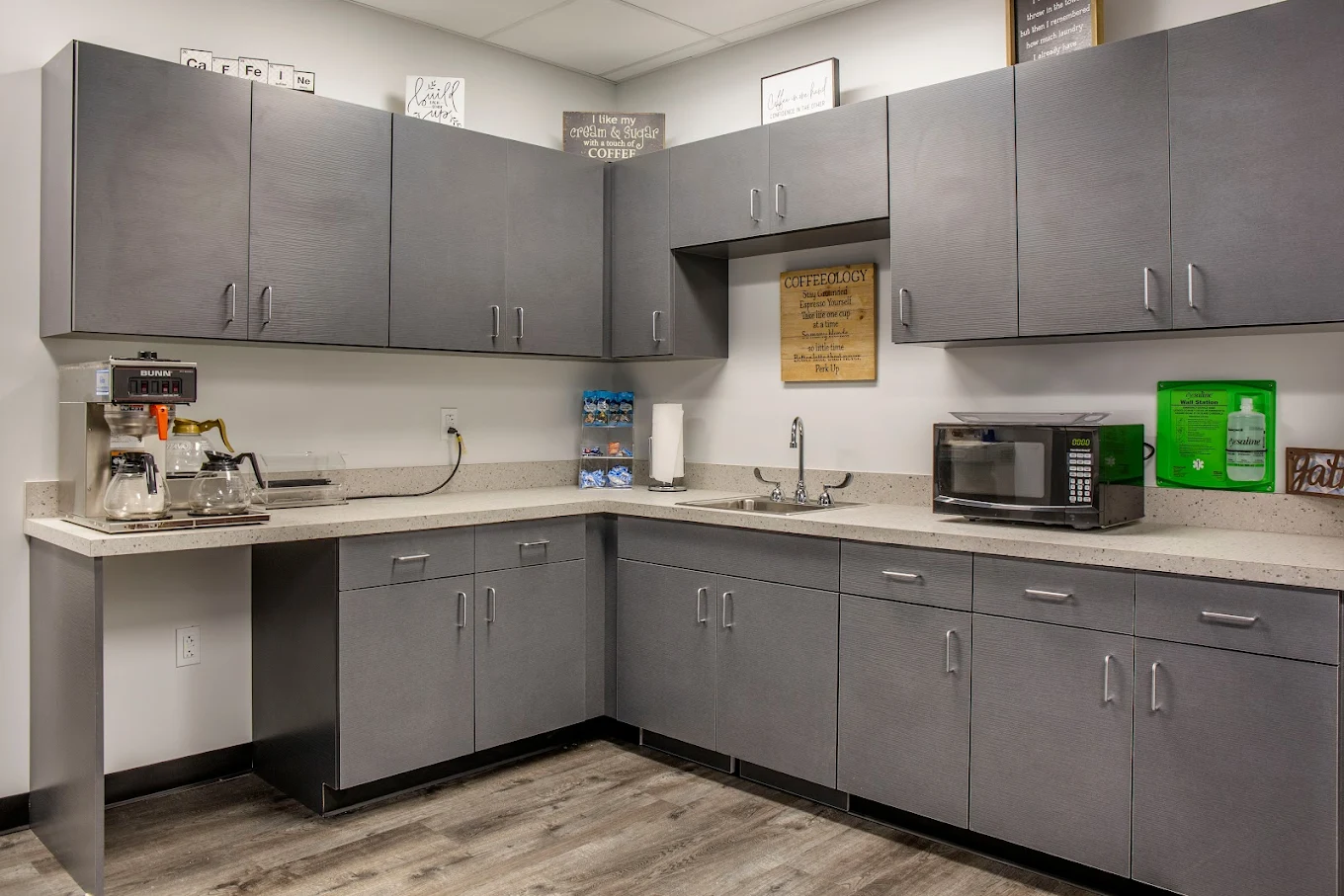 Kitchen with cabinets, coffee maker, sink, and microwave