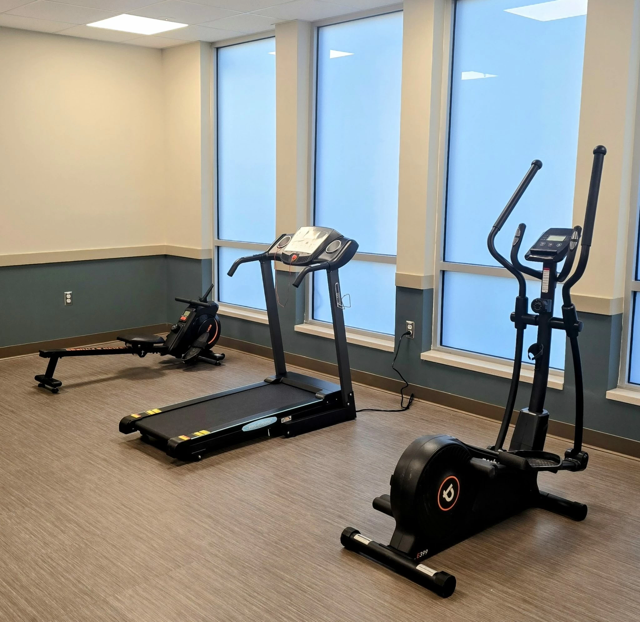 Fitness room with treadmill, elliptical and rowing machine