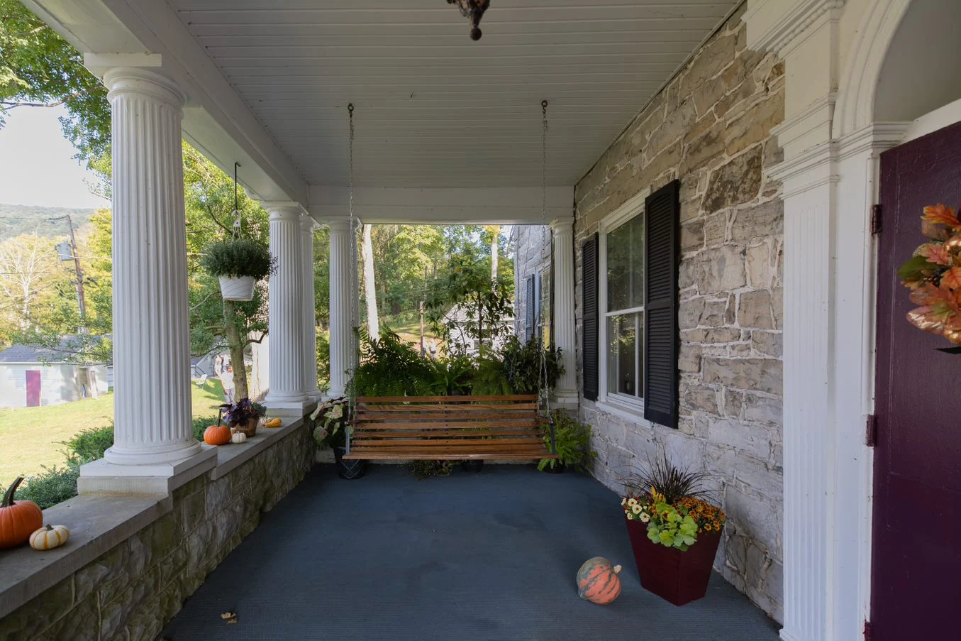Covered porch patio with seating and potted plants