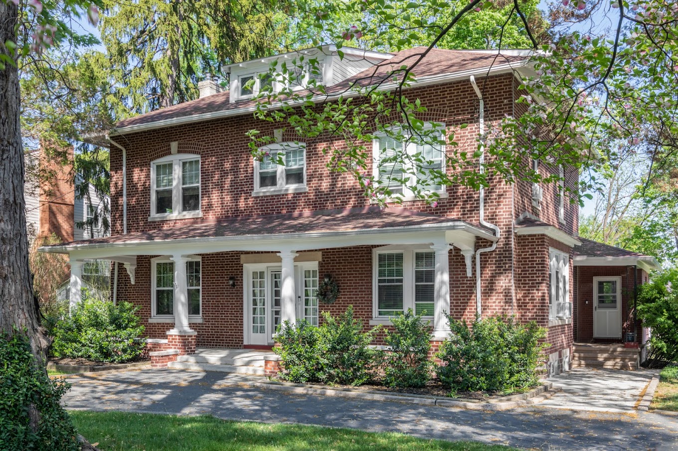 Brick building with front porch.
