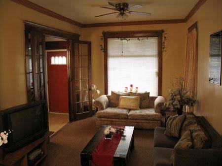 Warm living room with sofas, coffee table, and TV