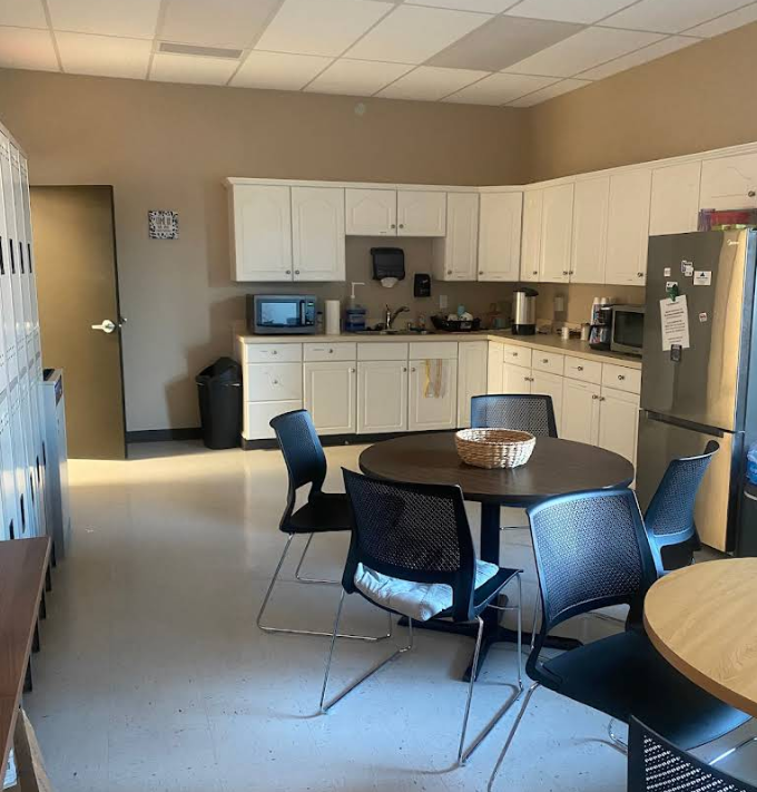 Kitchenette with tables, chairs, and appliances