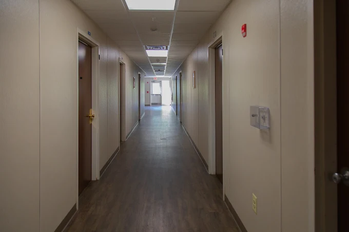 Interior hallway with wood floors and room doors