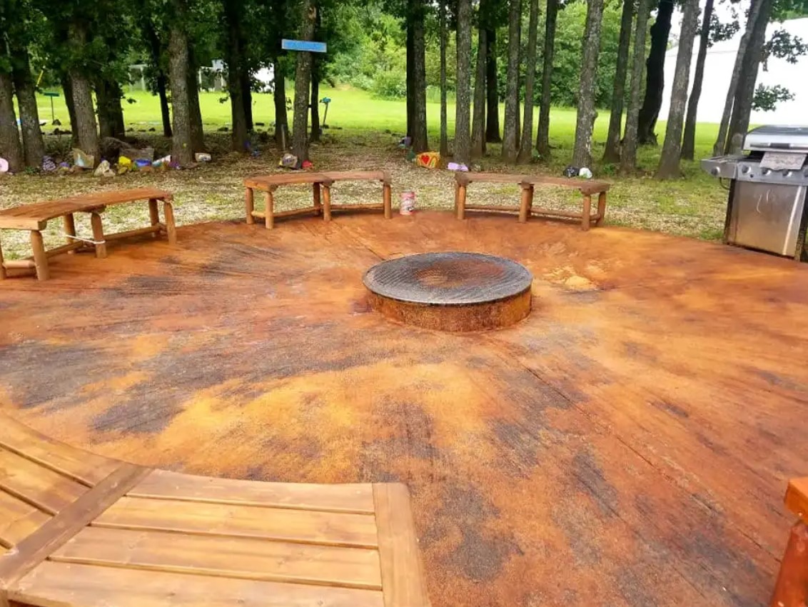 Spacious outdoor common area at Kisa Life Recovery Sedan, with seating around a fire pit, perfect for relaxation.