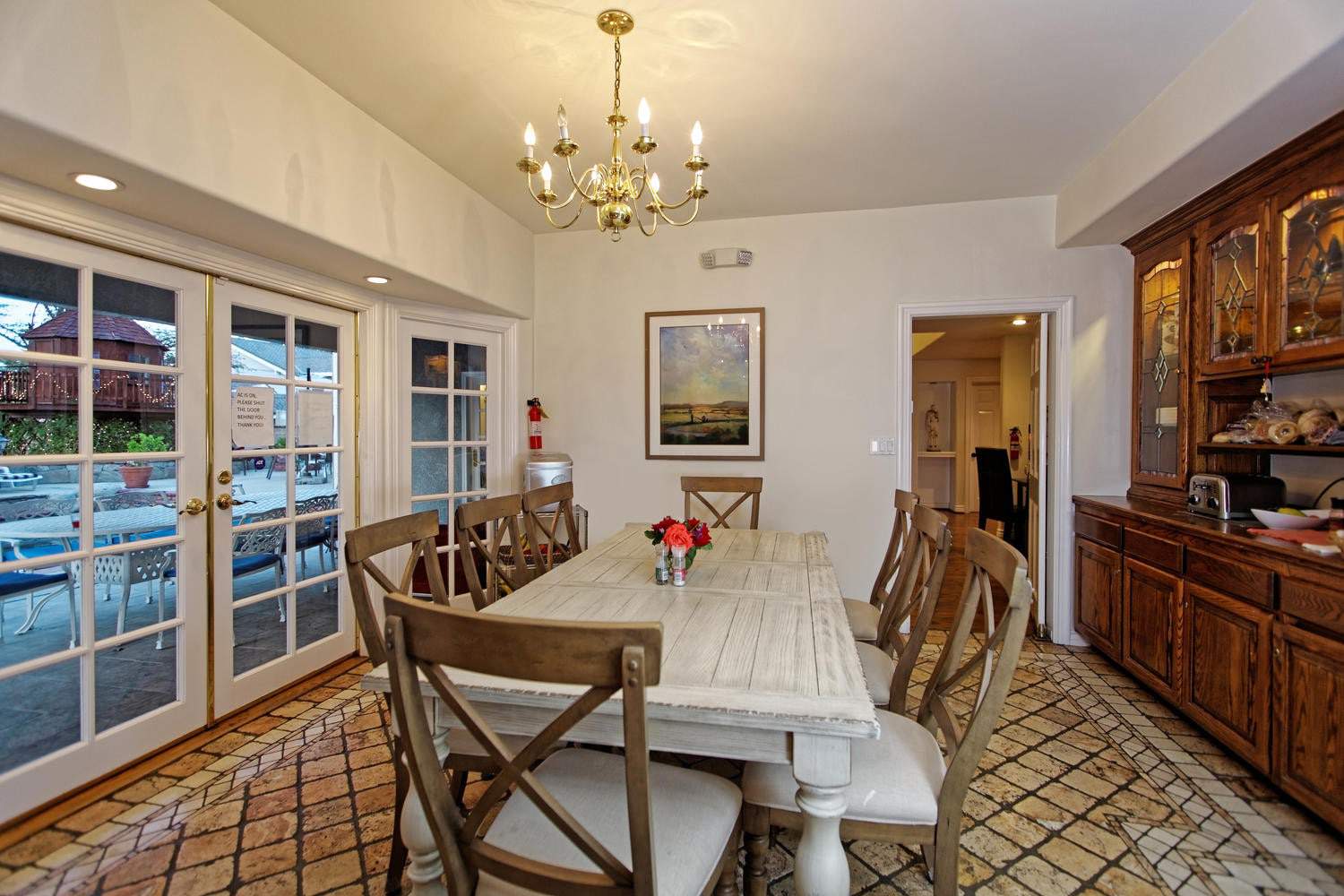 Dining table with eight chairs near French doors