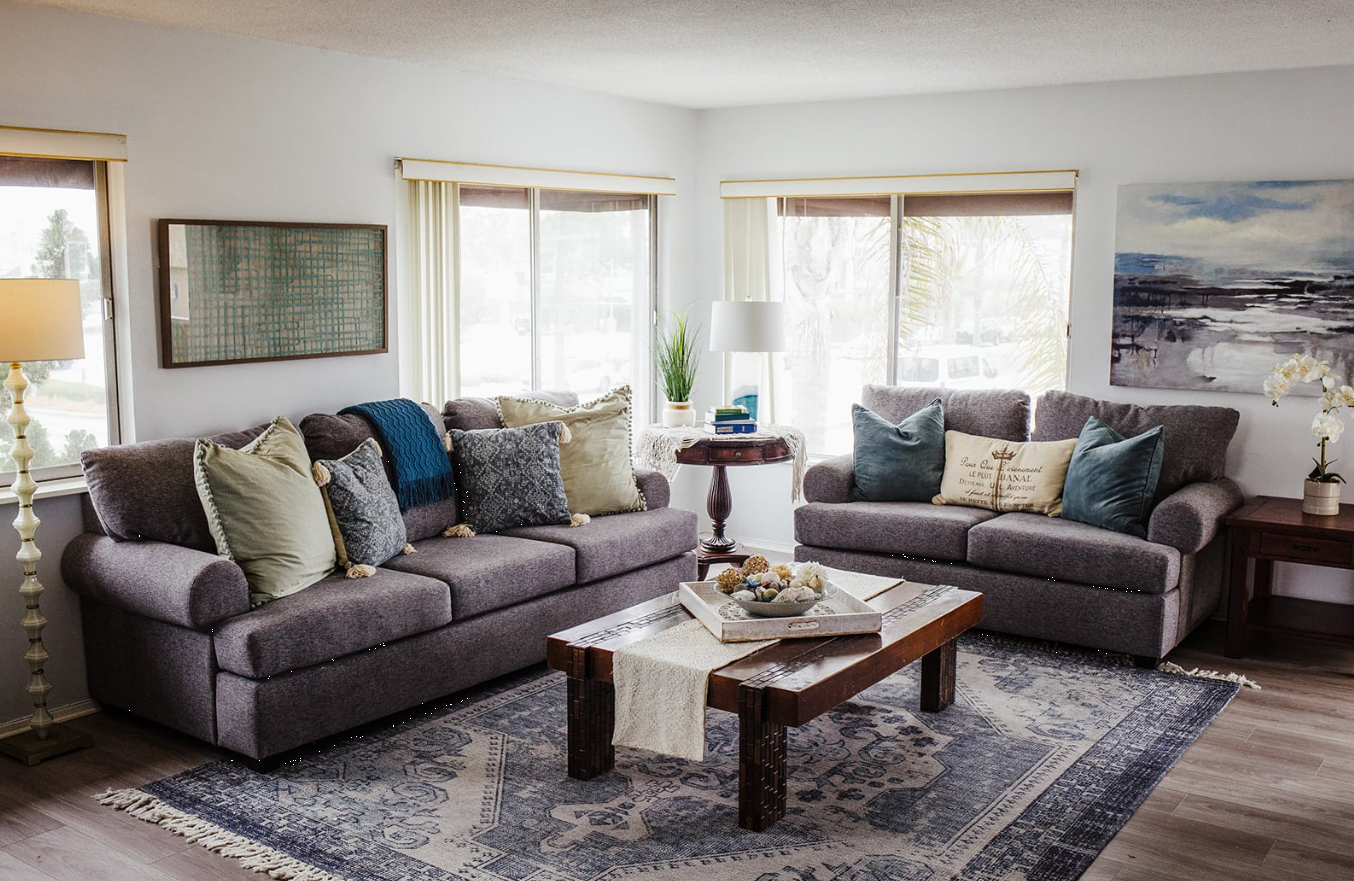 Bright living room with gray sofas and wooden coffee table