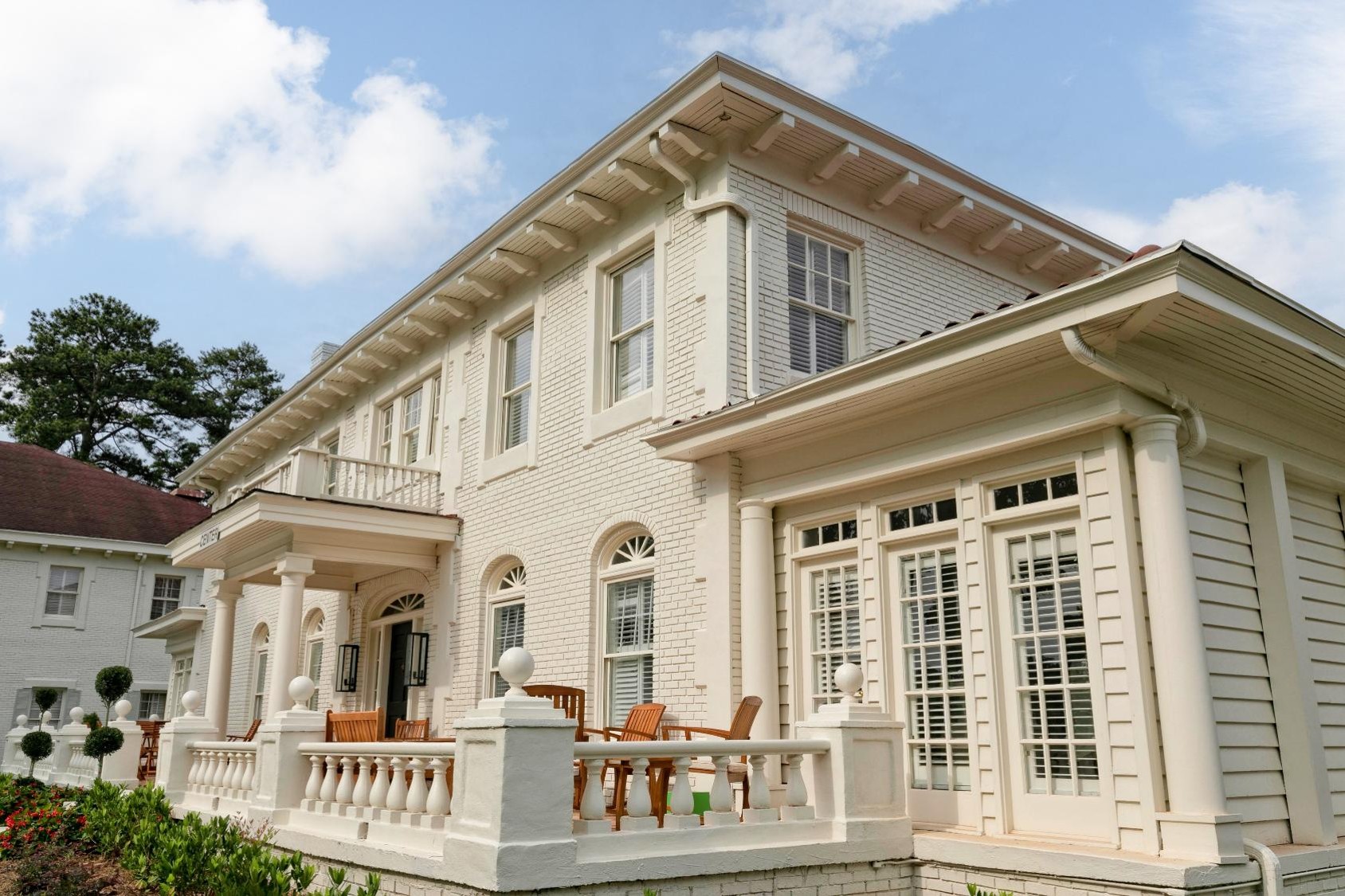 White brick building with red roof and columns
