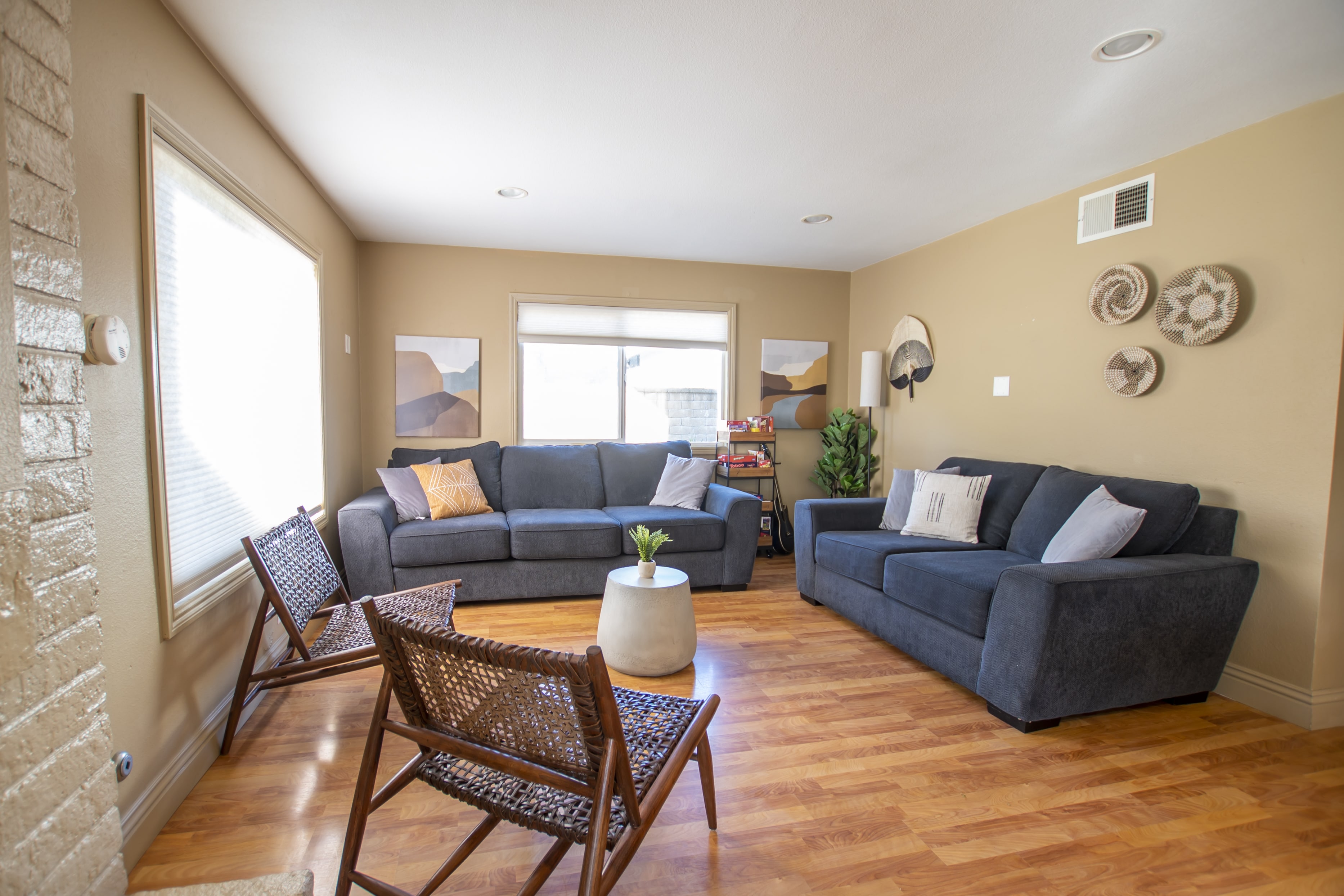 Cozy living room with two sofas and wicker chairs