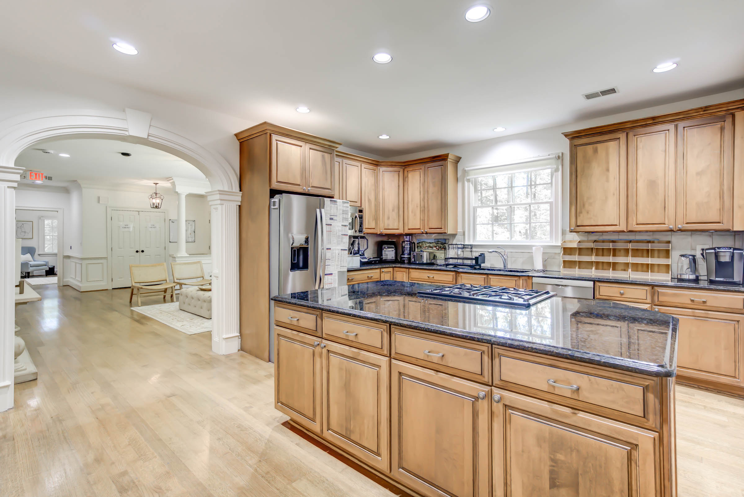 Kitchen with wood cabinets and granite island.