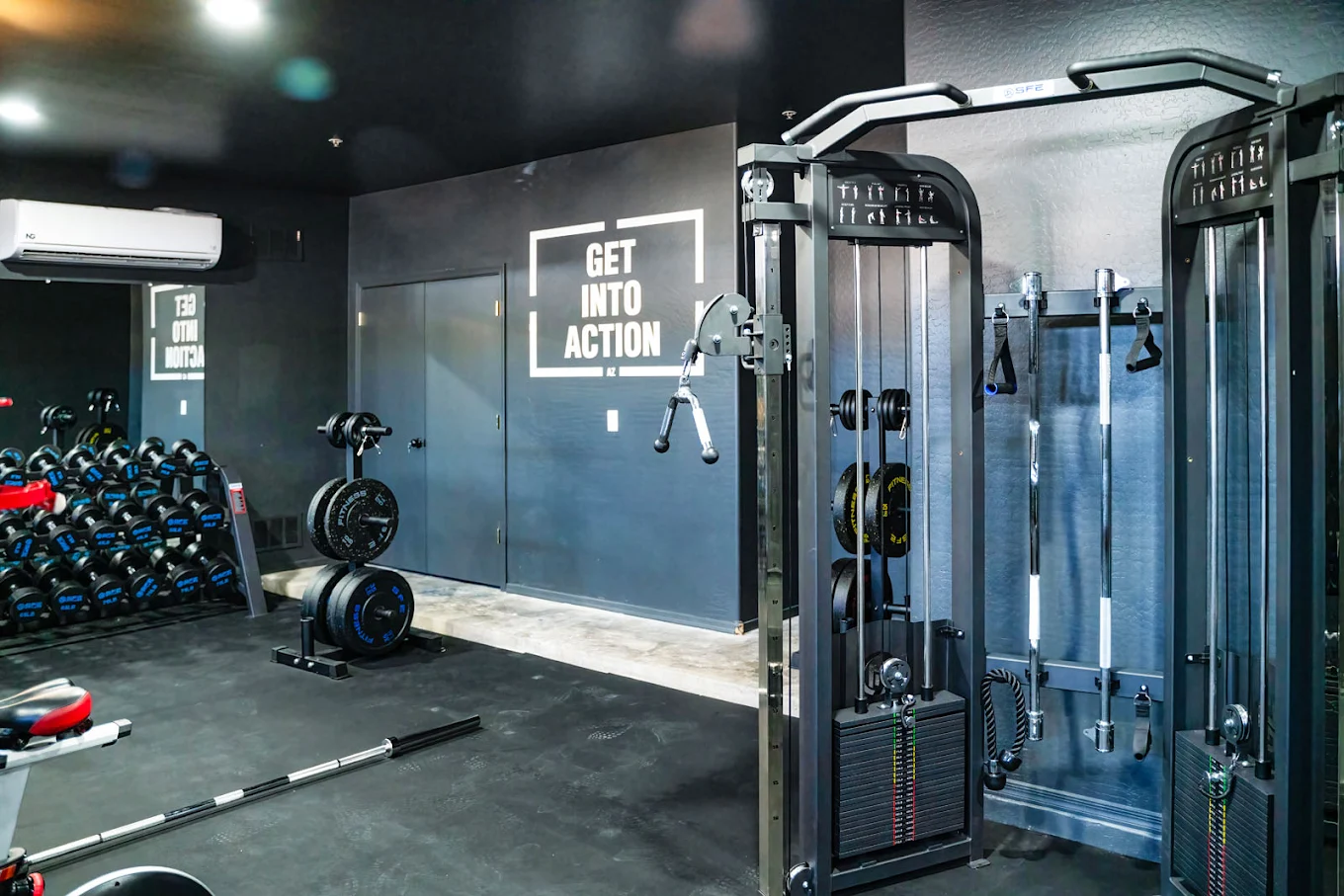 Gym with weights and cable machines and wall signage