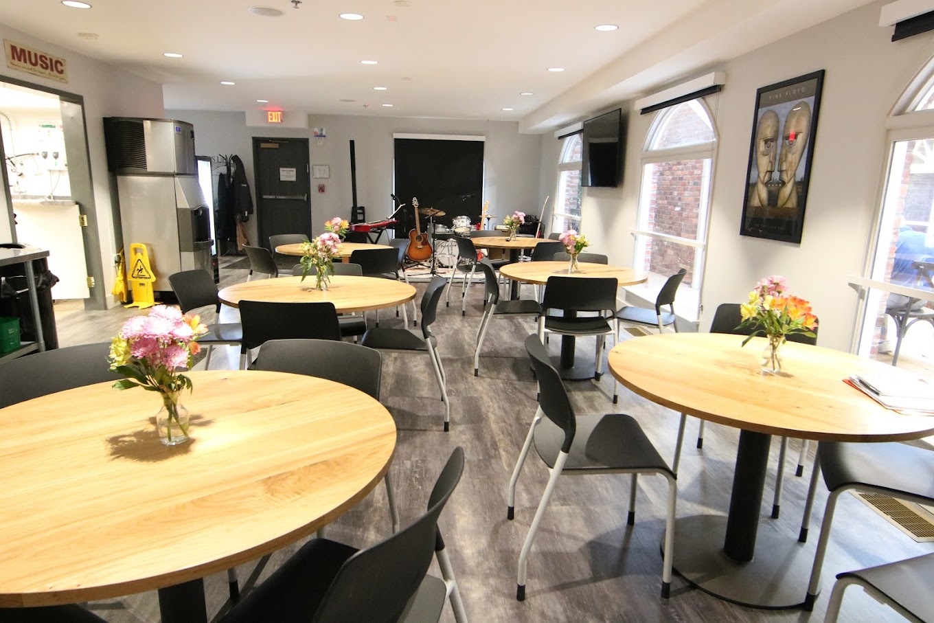 Round dining tables with floral centerpieces and chairs