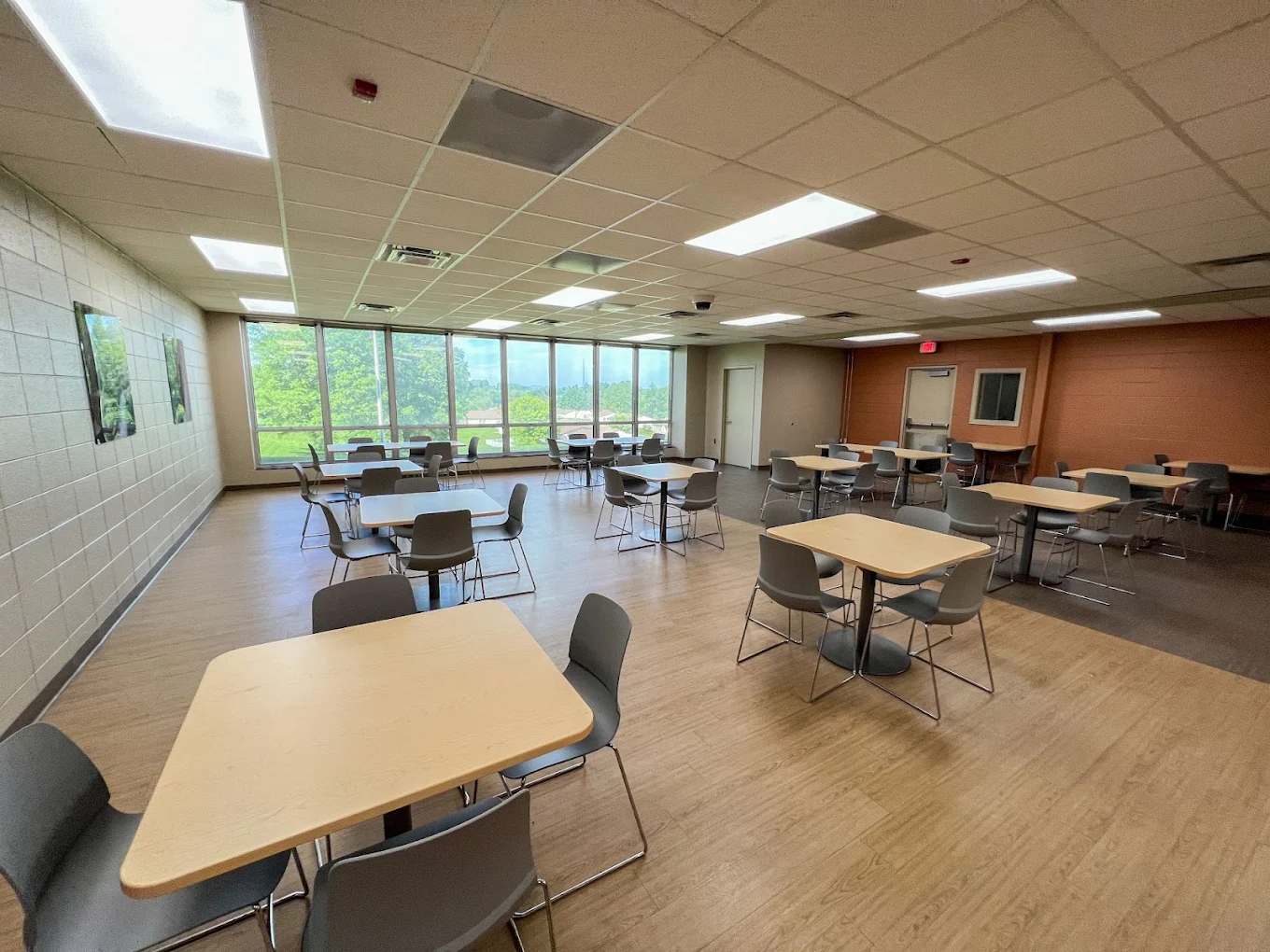 Spacious community dining room with tables and chairs