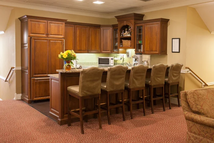 Kitchen with wooden cabinets and bar seating
