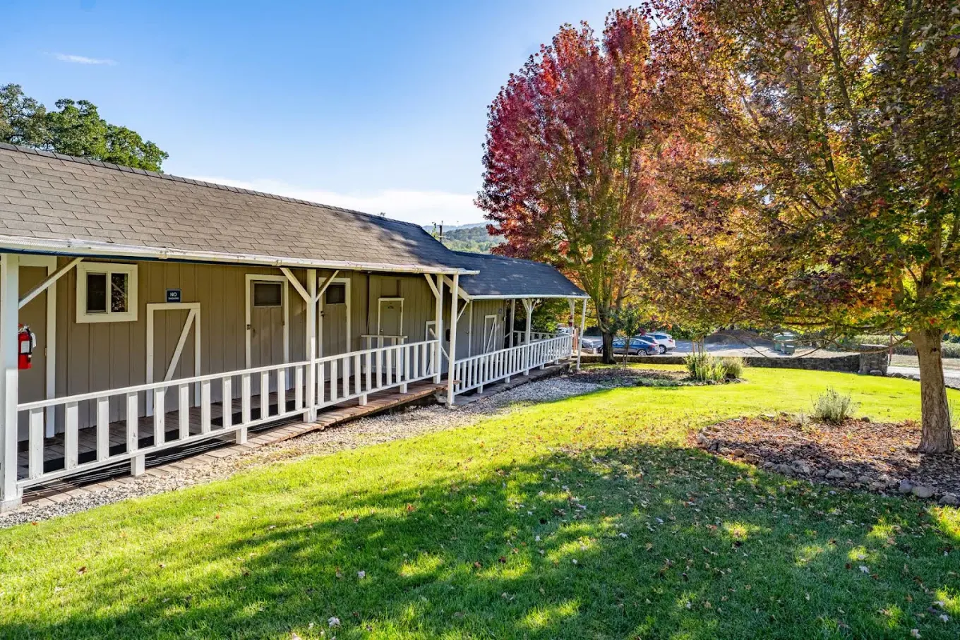Single-story residential building with porch and green lawn