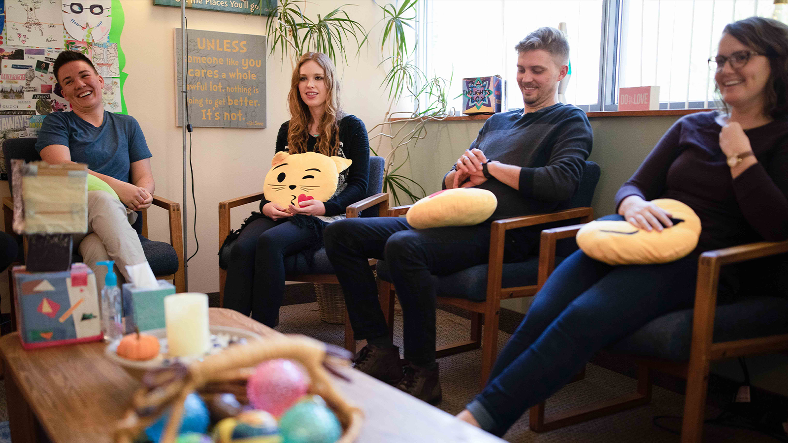 A group therapy session with people seated in a room.