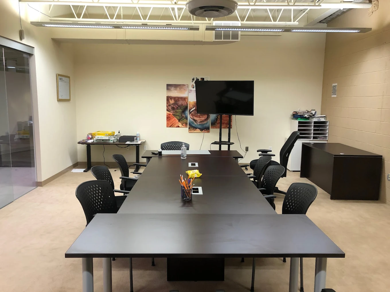 Meeting room with long table and TV screen