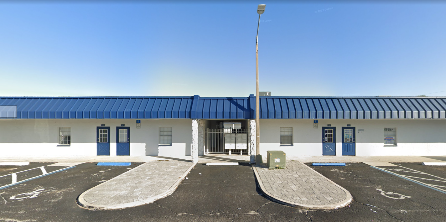 Facility exterior with the entrance and accessible parking.