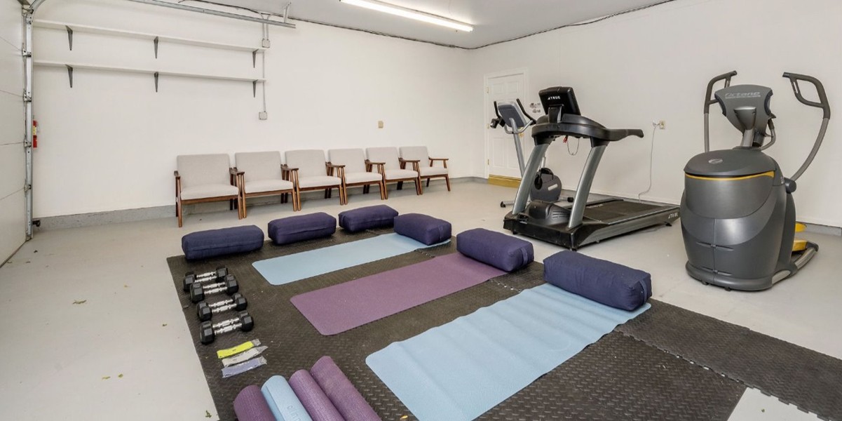 Exercise room with yoga mats and fitness machines