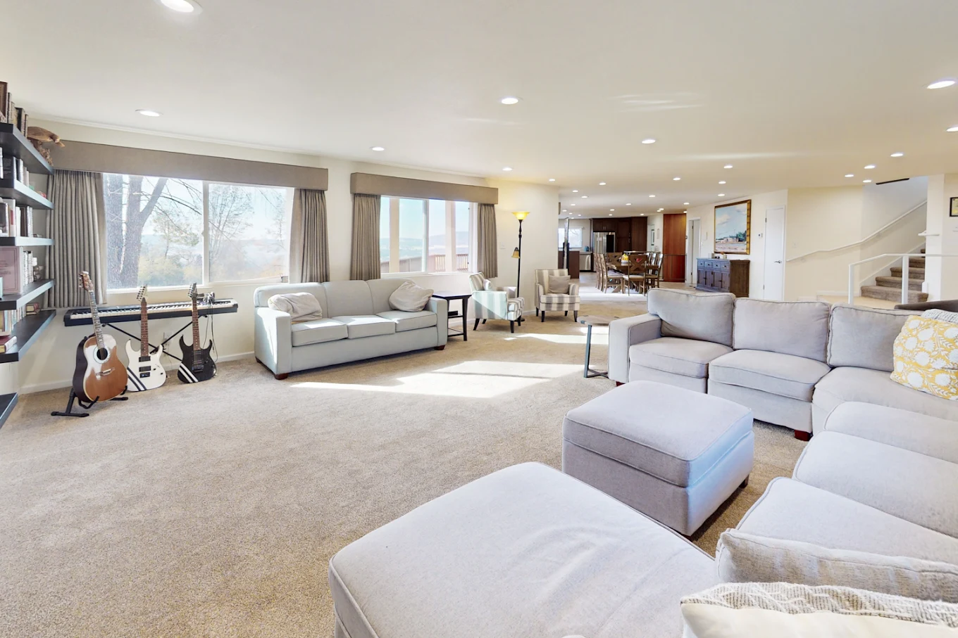 Guitars and couches in bright living room