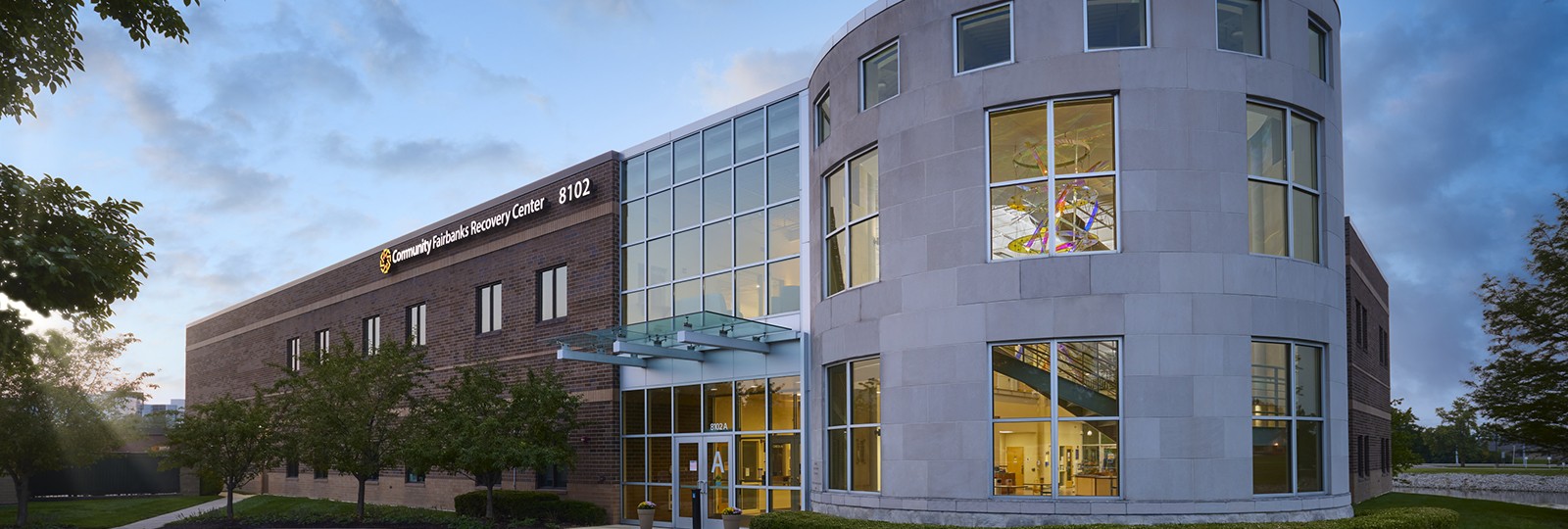 Modern recovery center building with glass entry and round tower
