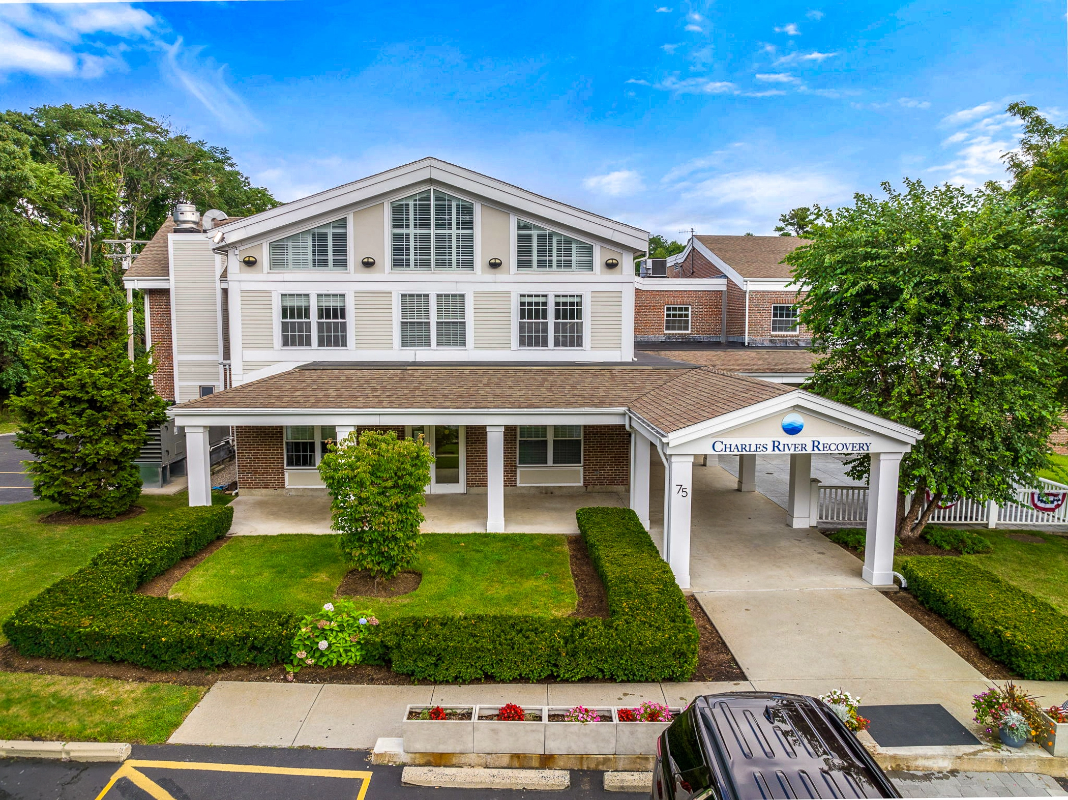 Facility with a signage over driveway and parking.