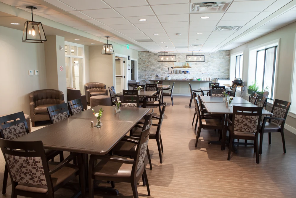 Tables and chairs in modern dining space with soft lighting