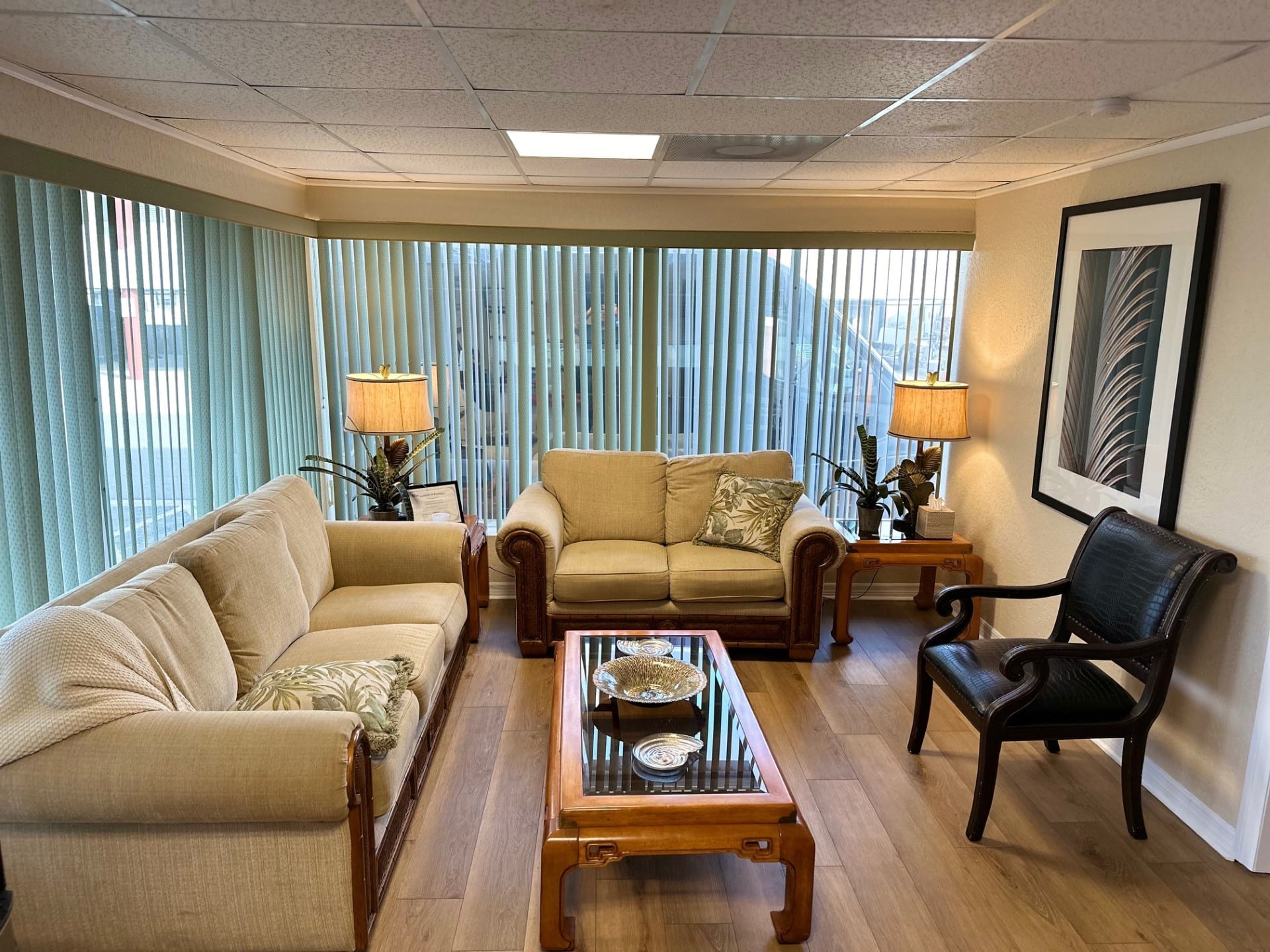 Waiting area with dark chairs and frosted window