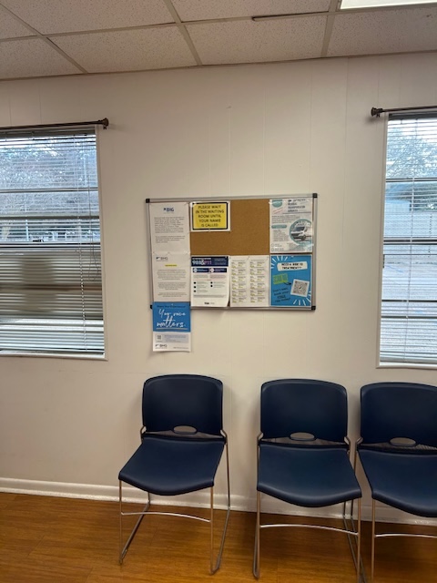 Waiting area with chairs and community information board