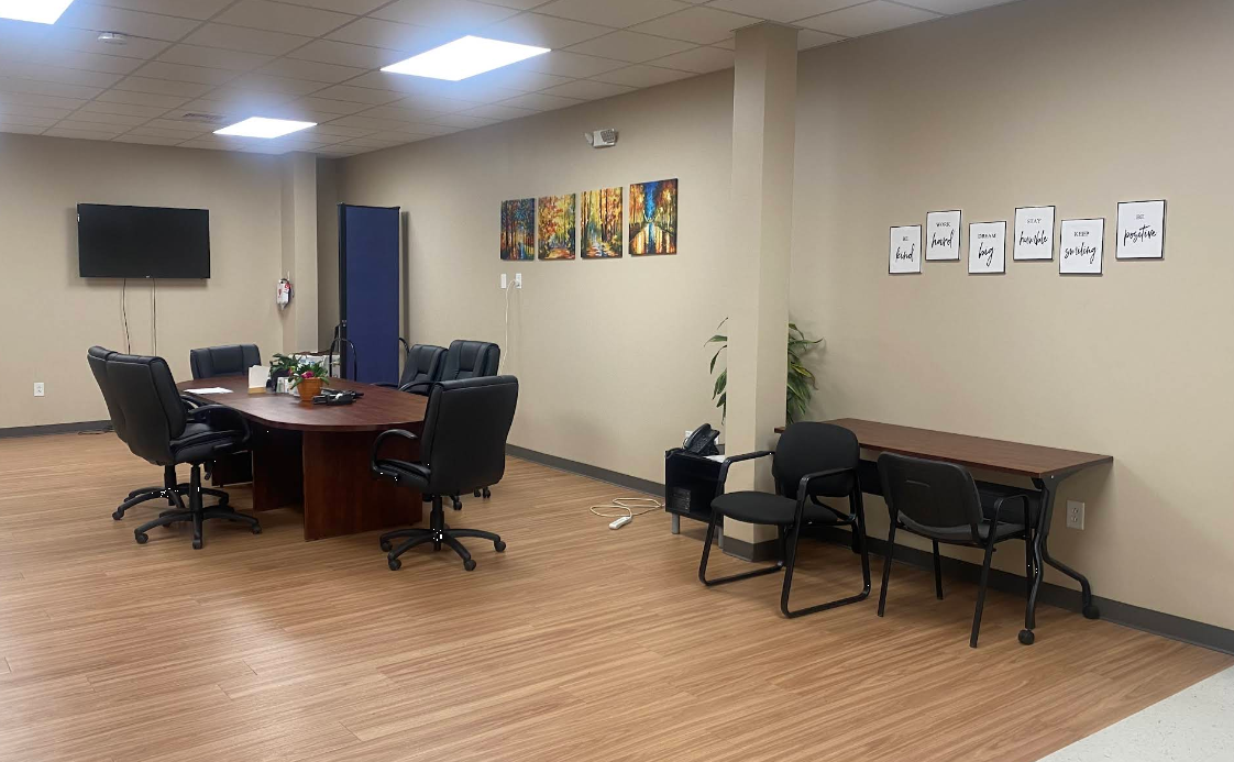 Meeting room with table, chairs, and wall art
