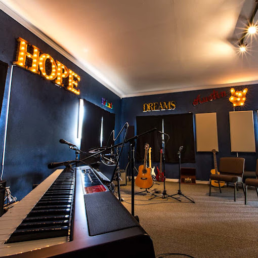 Piano and instruments under motivational wall signs
