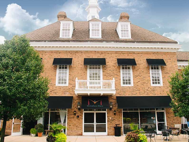 Brick building exterior with awnings and main entrance
