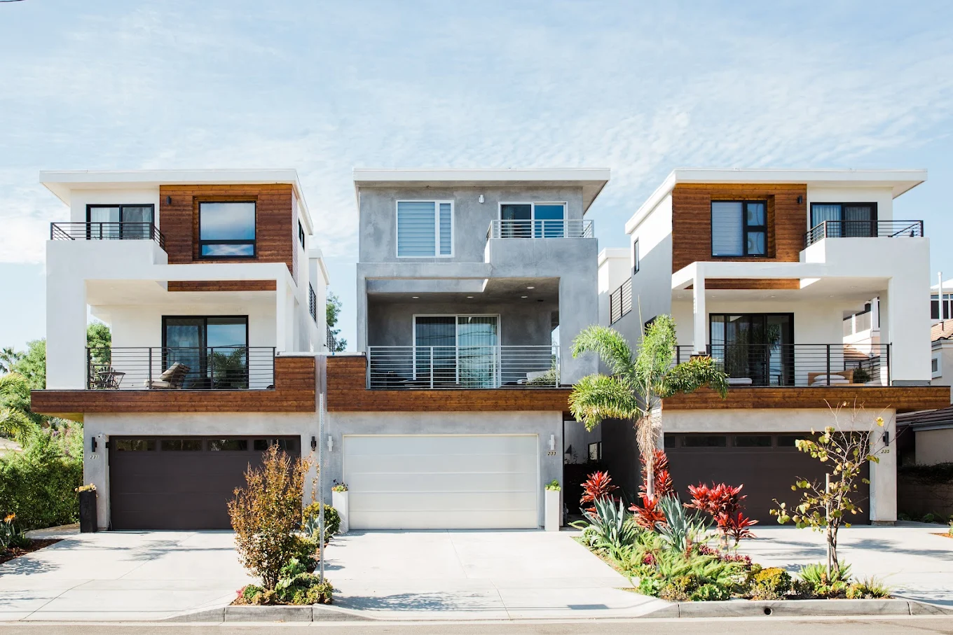 Modern multi-story home with balconies and garage