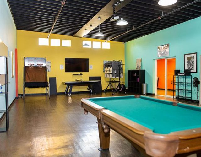 Pool table and games in colorful open recreation room