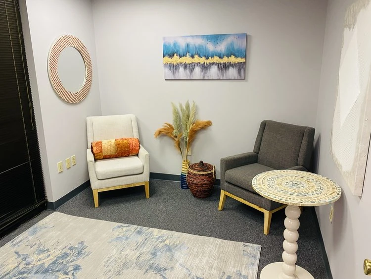 Two chairs with pillows and side table