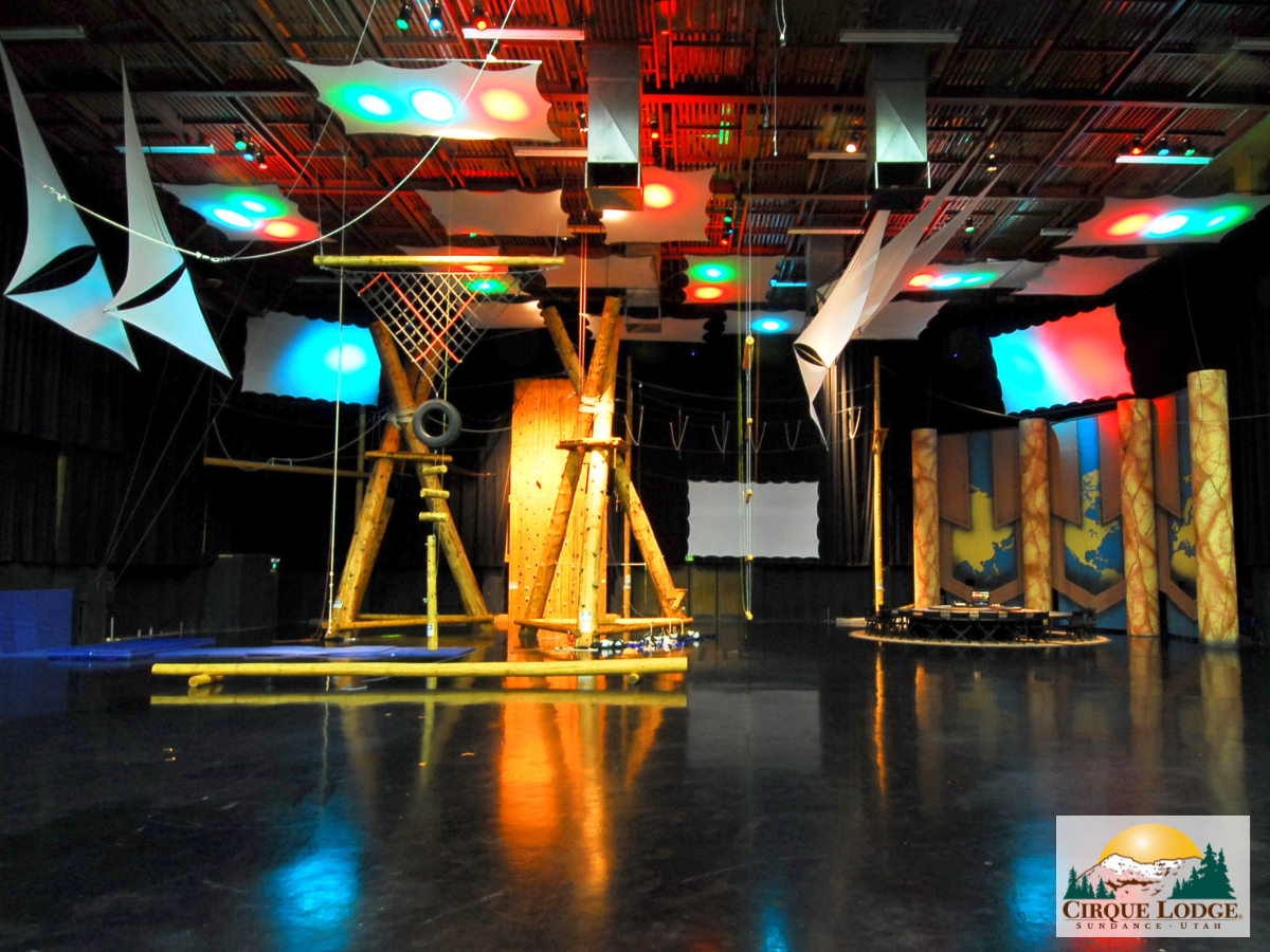 Indoor ropes course and climbing setup with colorful lights