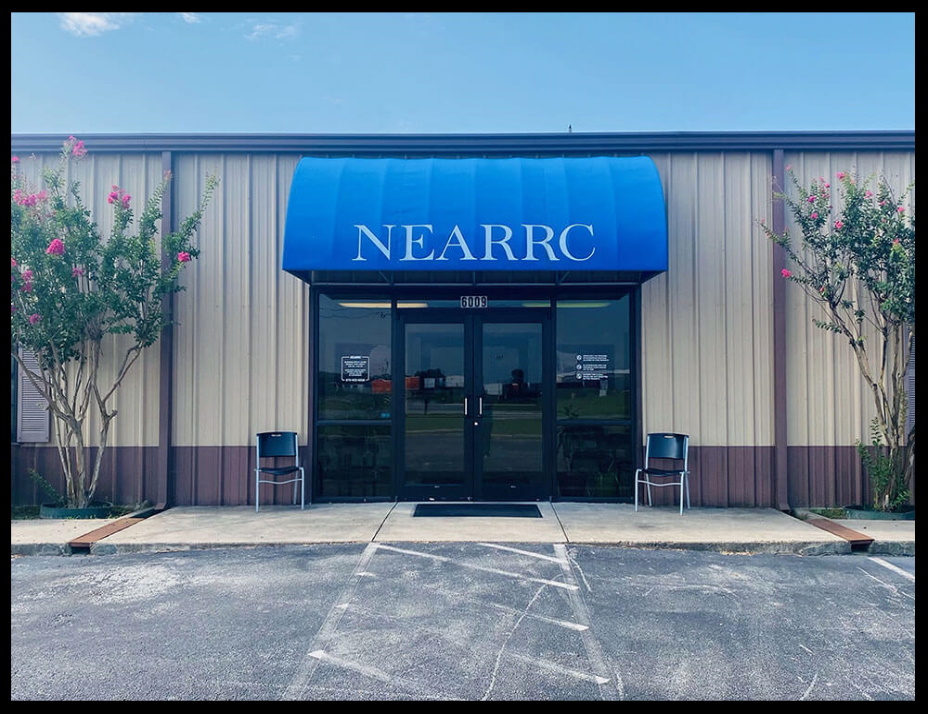 Front view of NEARRC building with blue awning and glass doors