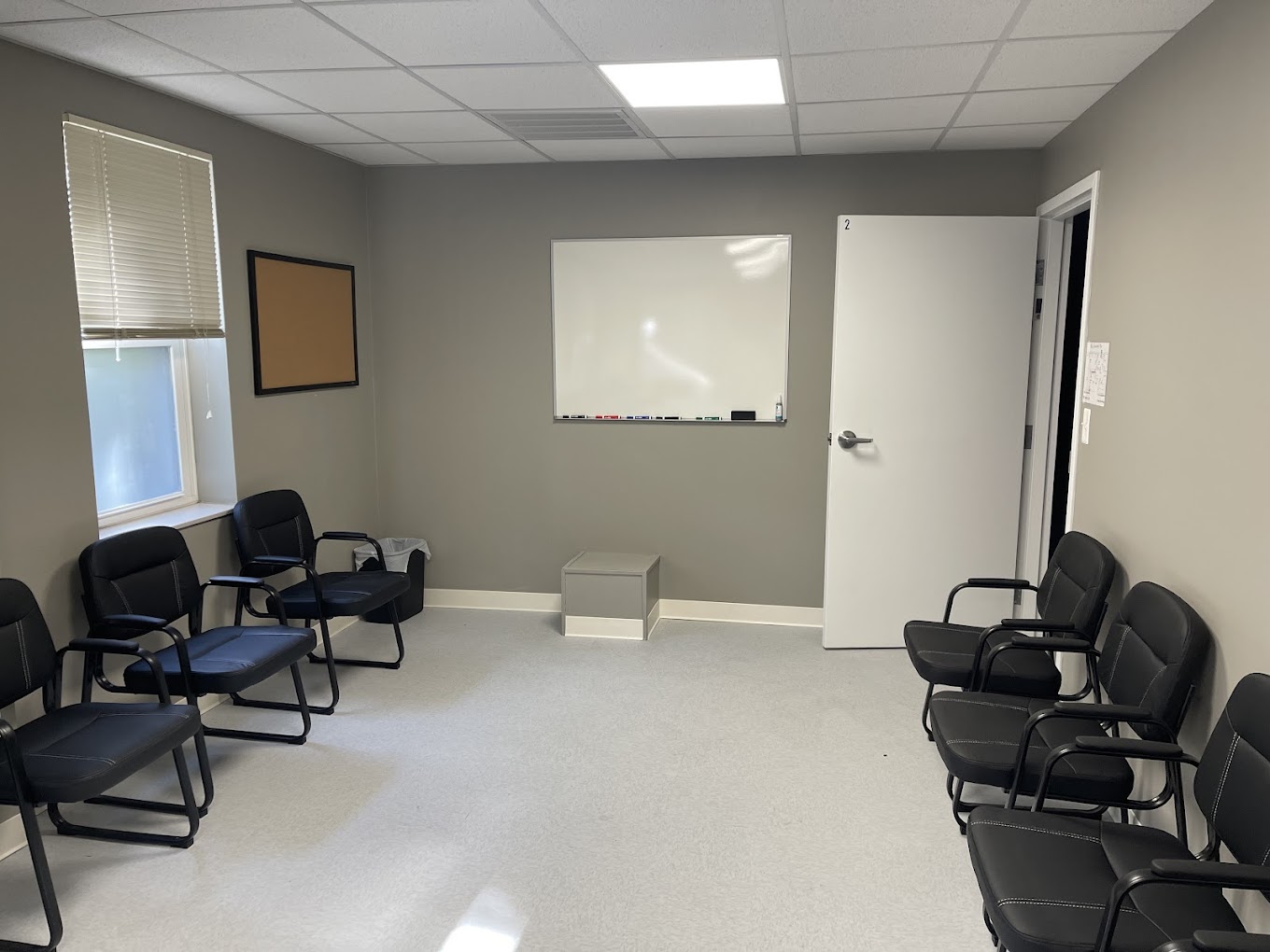 A group meeting room with chairs and a whiteboard.