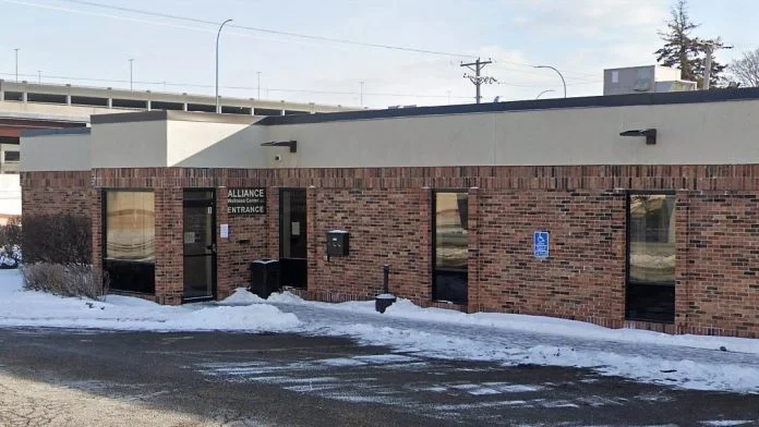Brick building with Alliance entrance and snowy walkway