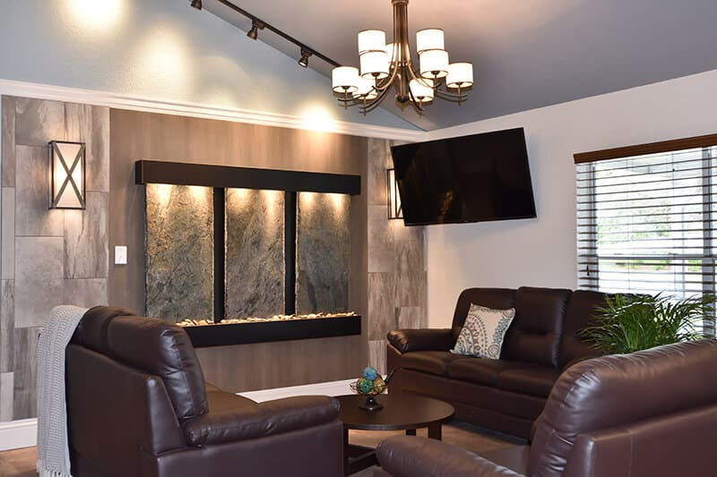 Lounge with leather seating, TV, and water feature