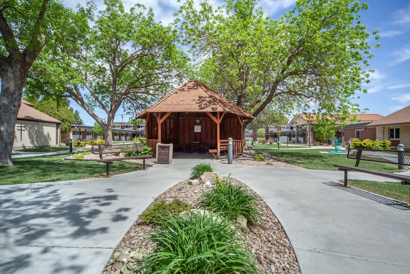 Outdoor courtyard with gazebo seating and landscaped paths