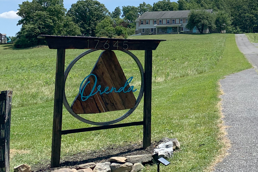 Entrance sign for Orenda Center for Wellness on scenic property