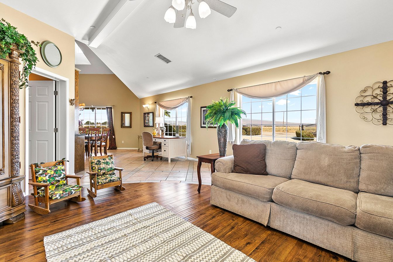 Cozy lounge with large windows and sofa seating