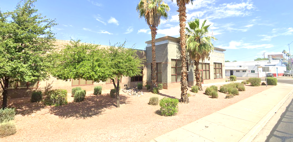 Side view of Florence Crittenton Therapeutic Group Home with palm trees and desert shrubs.