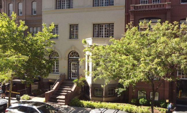 Residential facility exterior with trees and front entrance