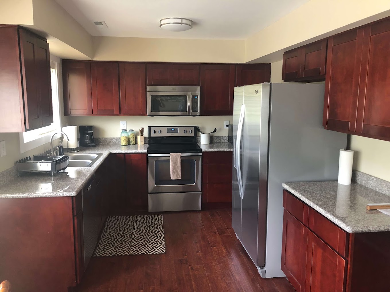 Full kitchen with stainless appliances and wood cabinets