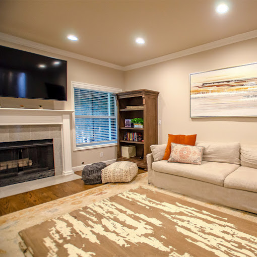 Living room with a fireplace, a sofa, and a TV.