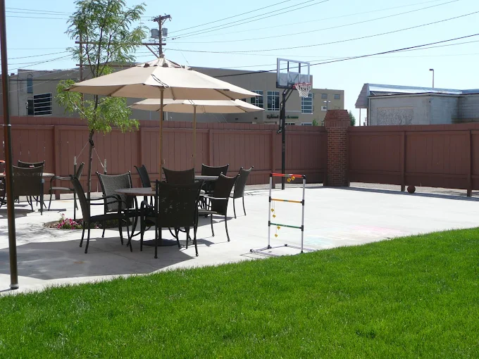 Outdoor space with basketball hoop and seating