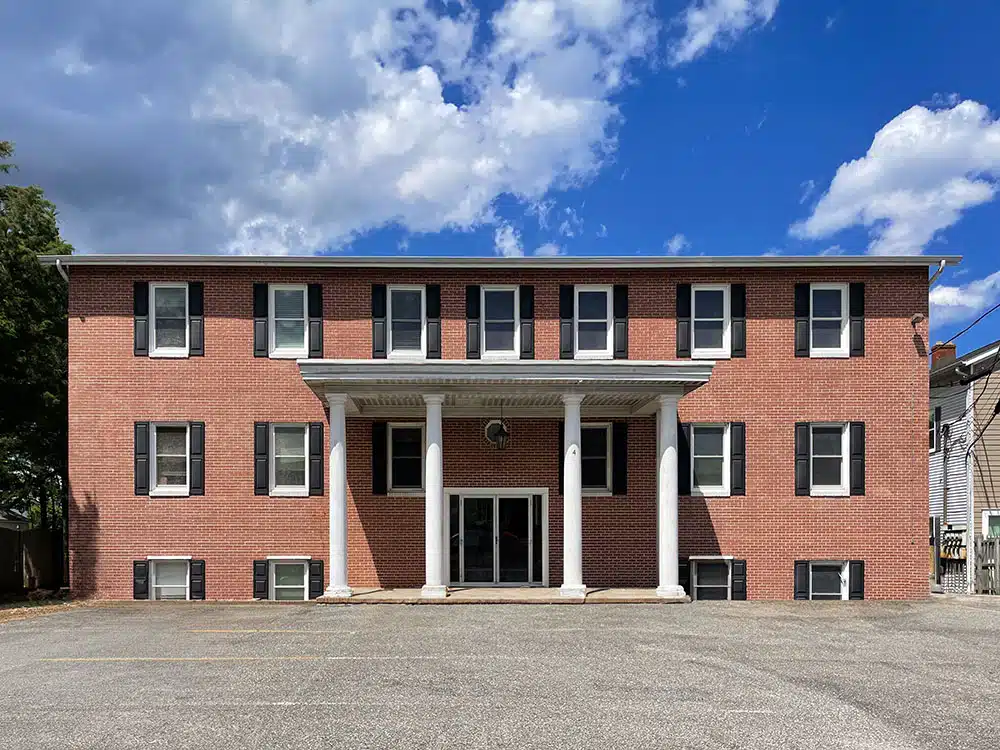 Brick building with columns and main entrance doors